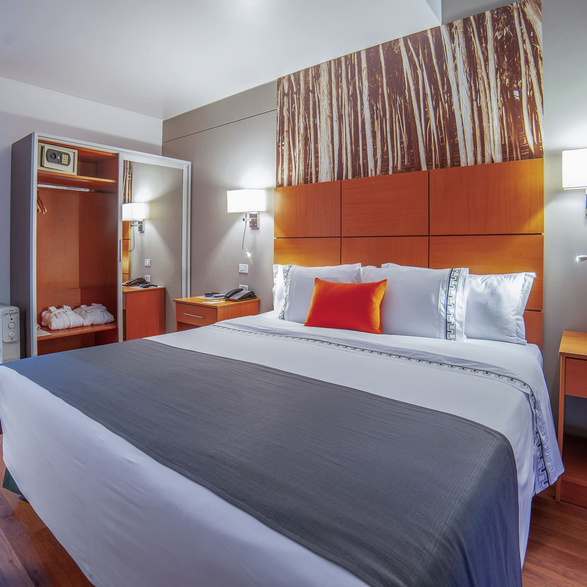 a bed with a wood headboard and a wood paneled wall