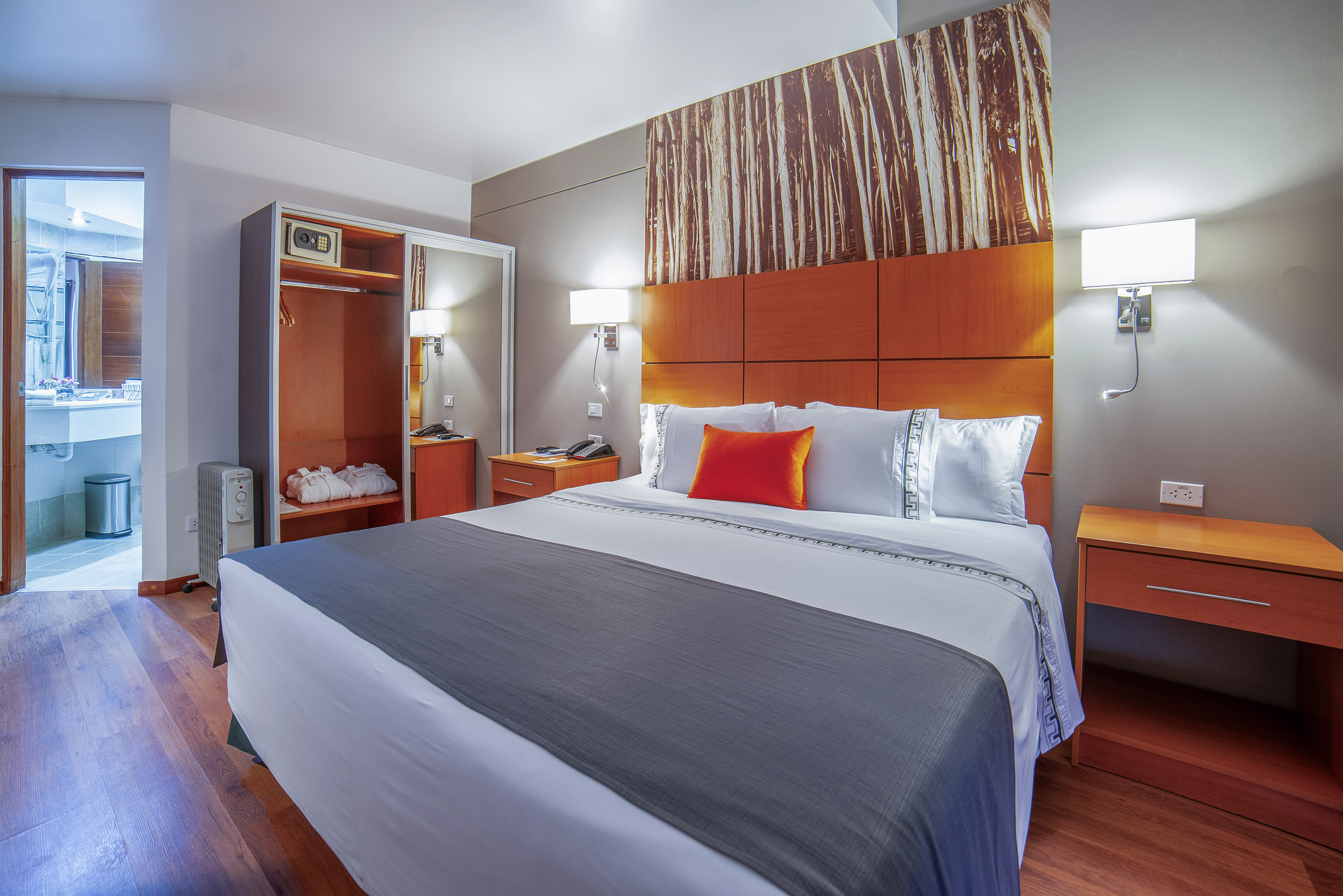 a bed with a wood headboard and a wood paneled wall