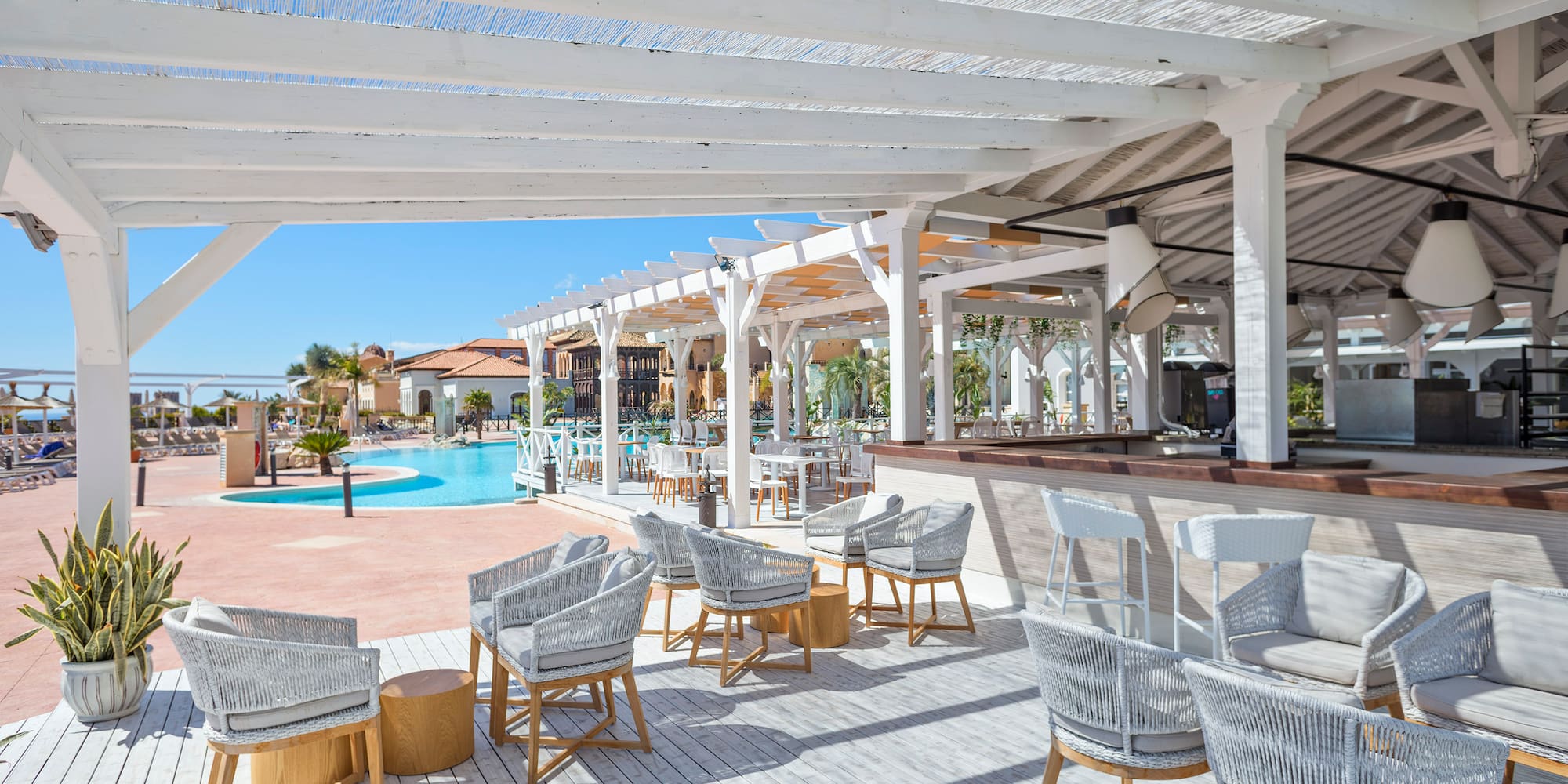 a pool with chairs and tables