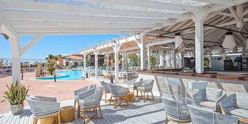 a pool with chairs and tables