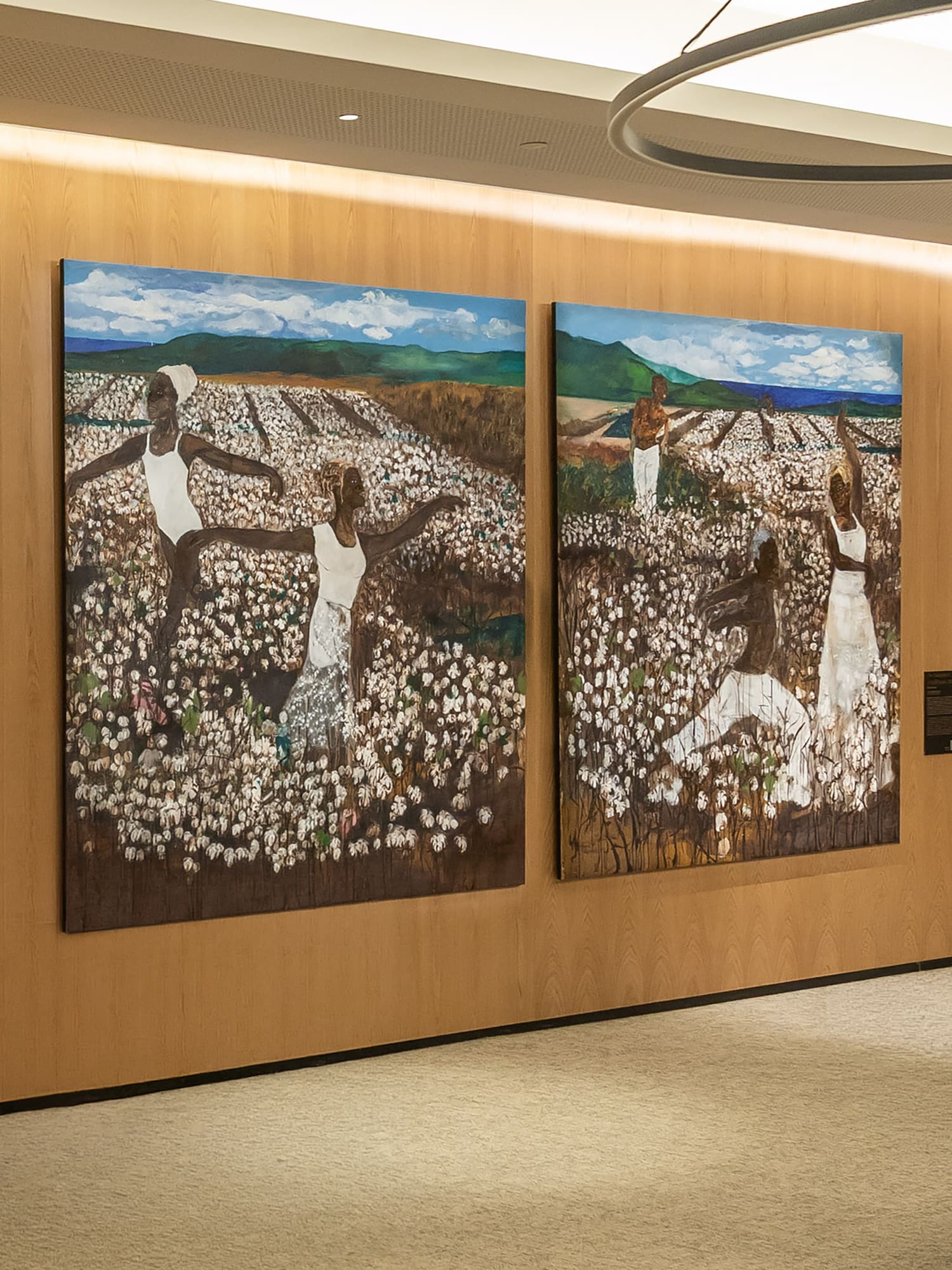 Two colorful paintings of Black women in a cotton field, art exhibition.