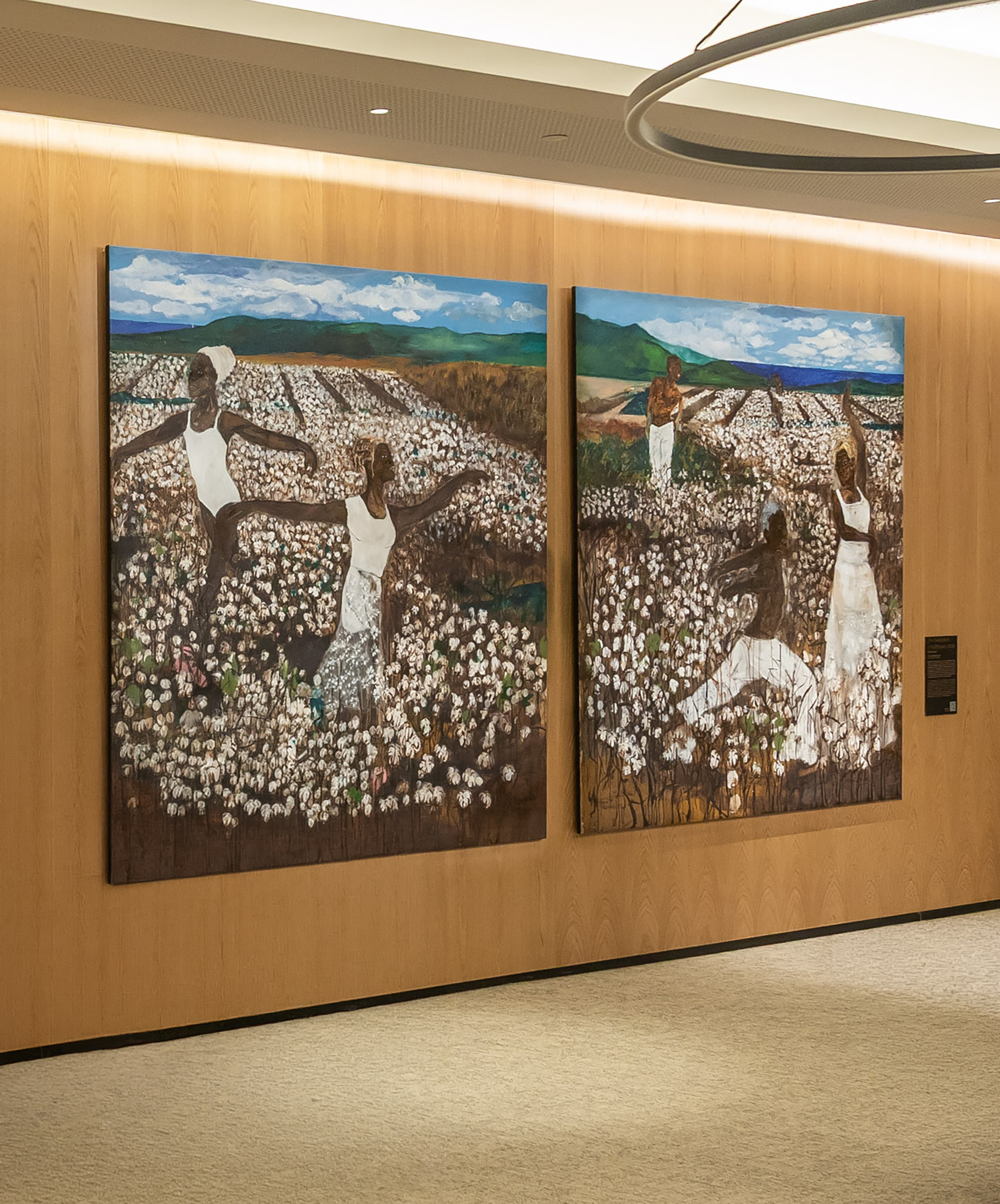 Two colorful paintings of Black women in a cotton field, art exhibition.