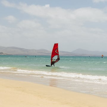 a person on a sailboat in the water