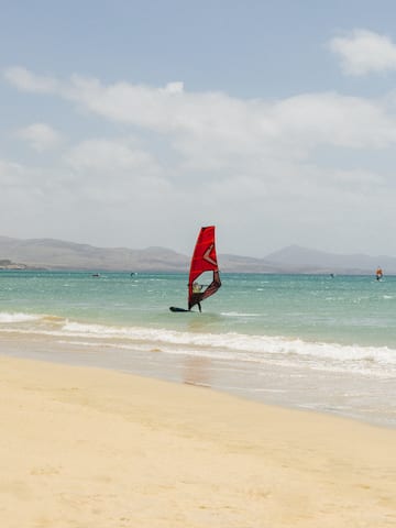 a person on a sailboat in the water