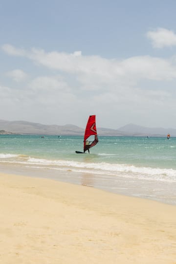 a person on a sailboat in the water
