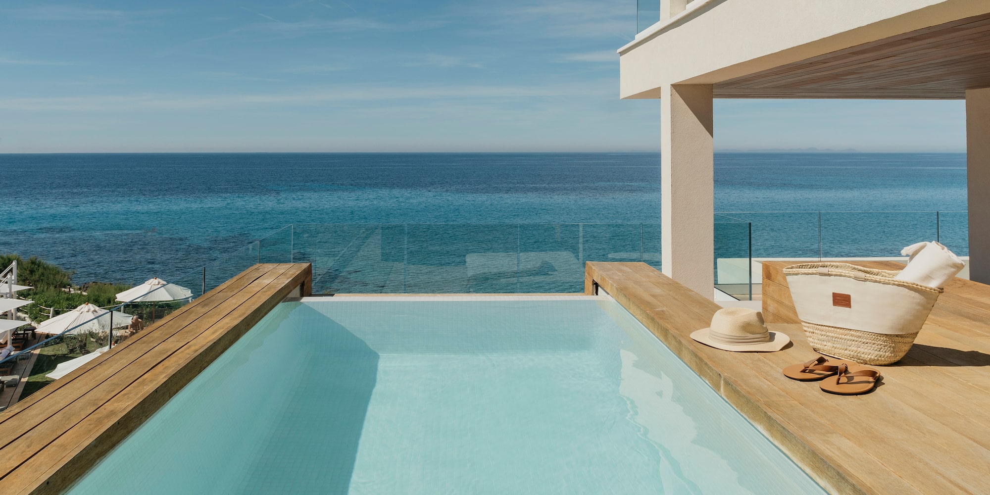 a pool with a deck overlooking the ocean