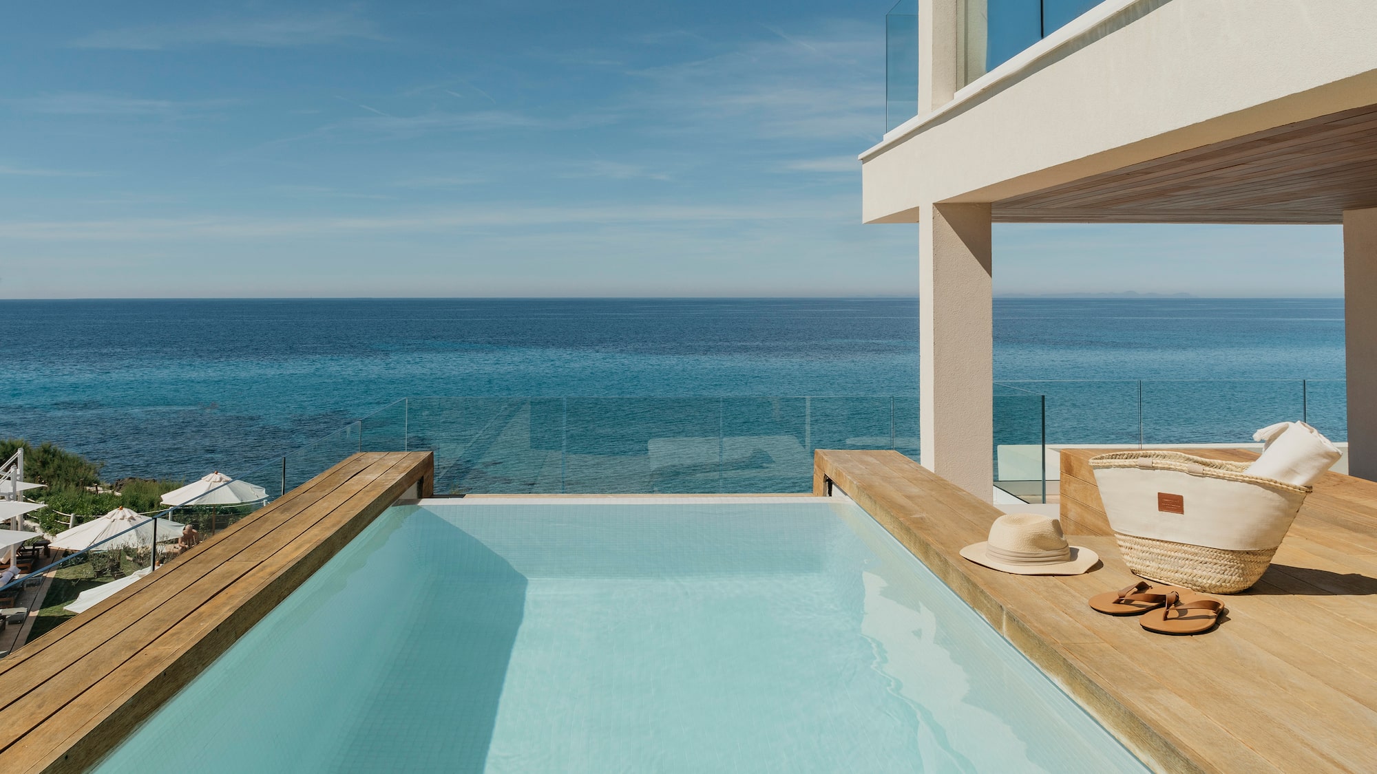 a pool with a deck overlooking the ocean