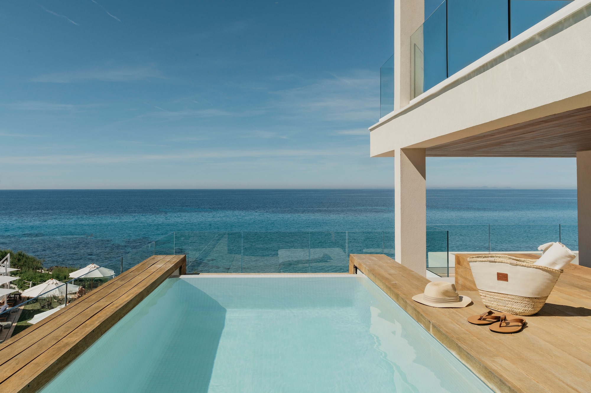 a pool with a deck overlooking the ocean