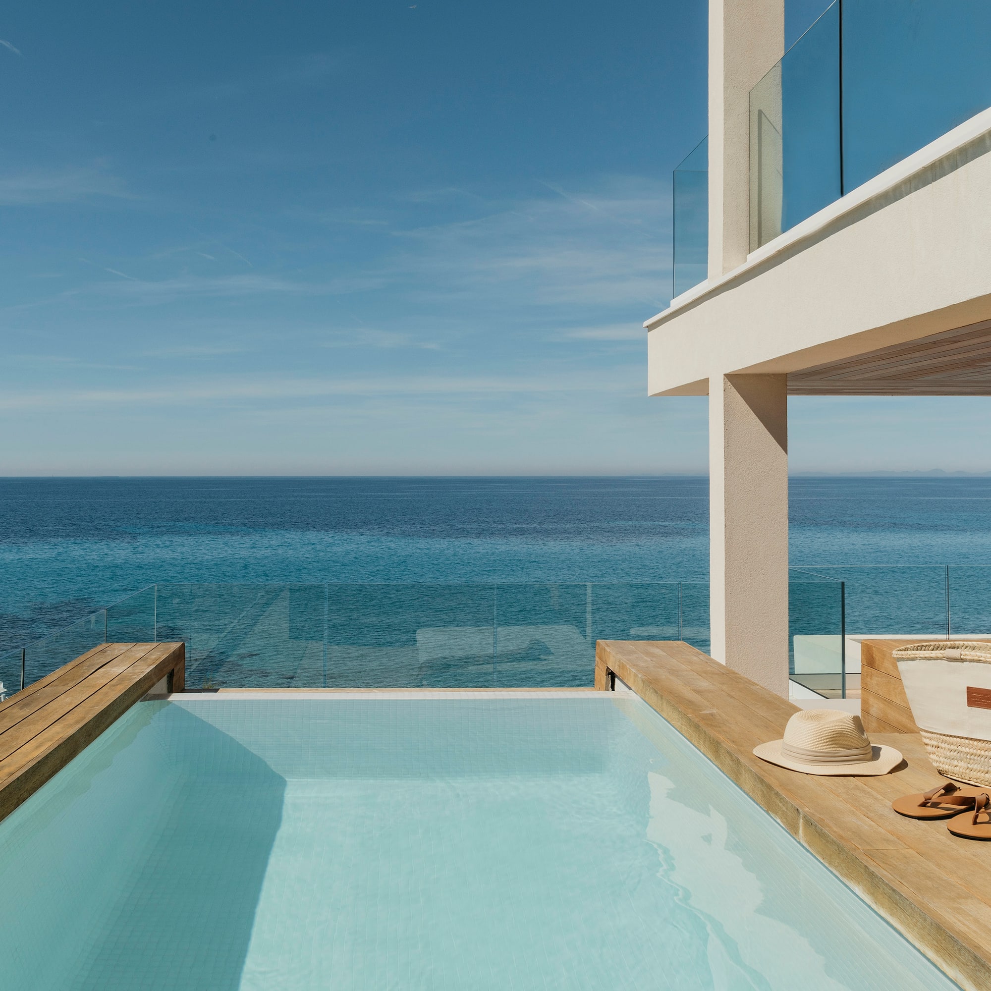 a pool with a deck overlooking the ocean