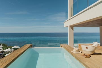 a pool with a deck overlooking the ocean