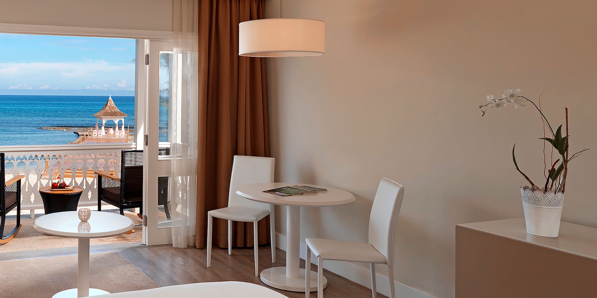 a room with a table and chairs and a door to a balcony