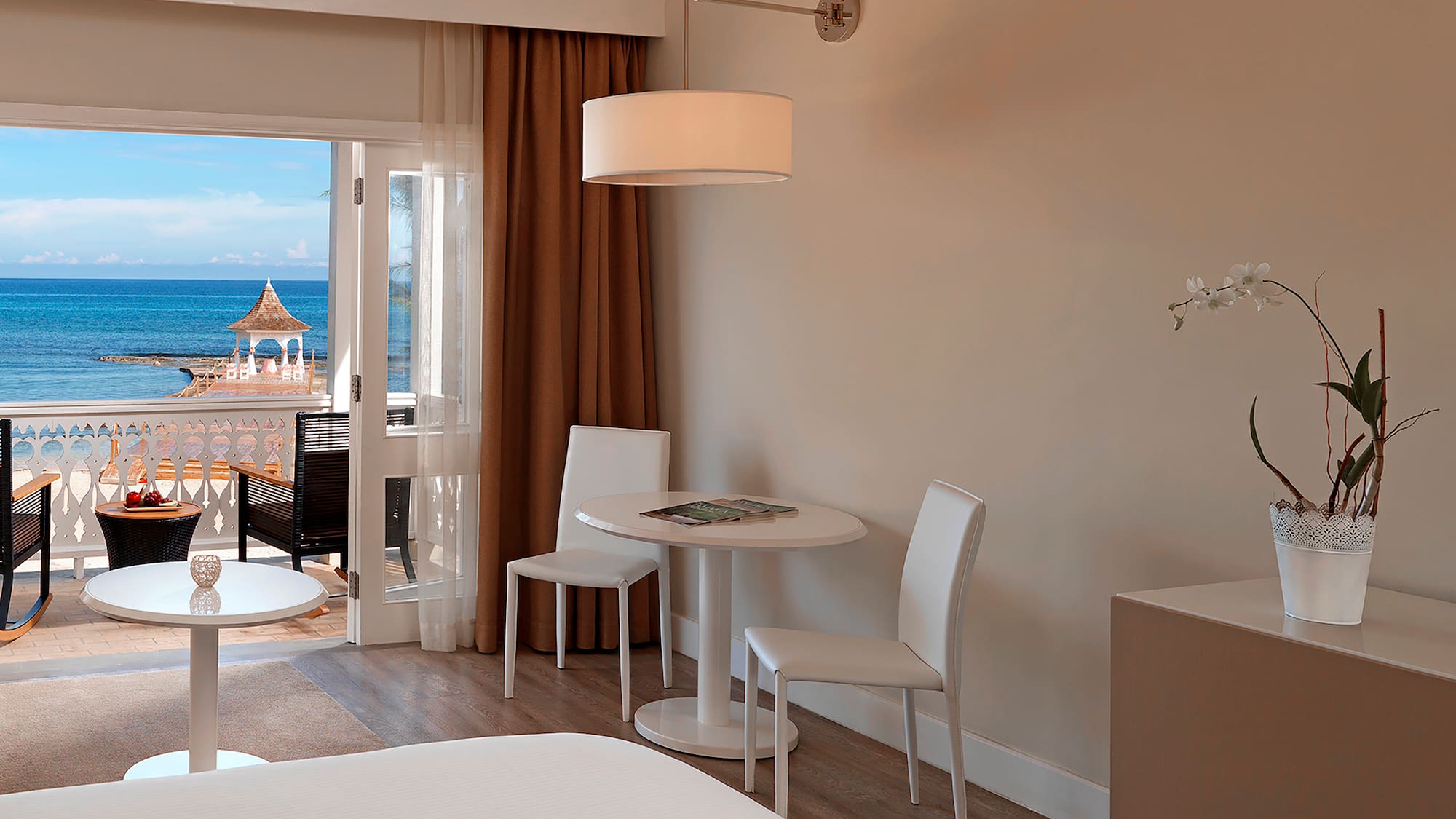 a room with a table and chairs and a door to a balcony