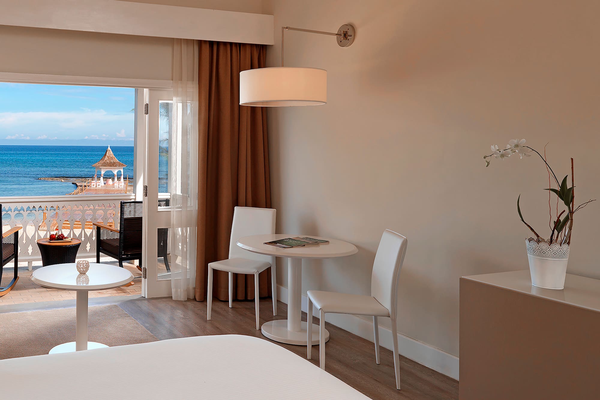 a room with a table and chairs and a door to a balcony