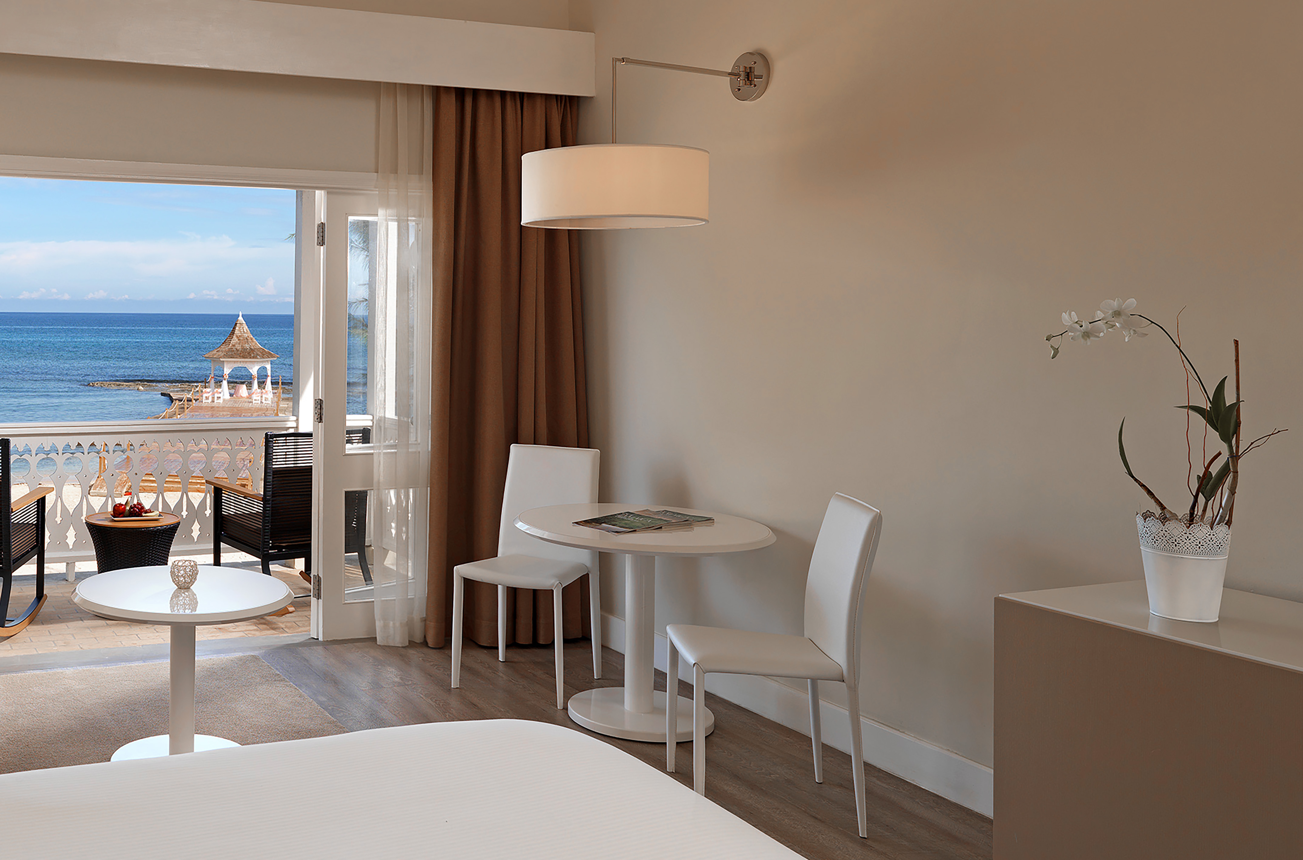 a room with a table and chairs and a door to a balcony