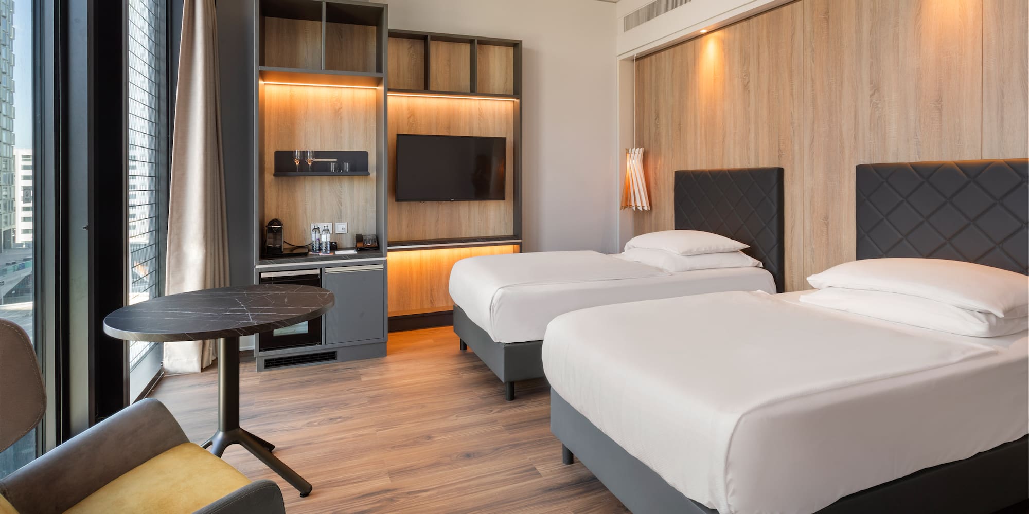 a room with two beds and a table