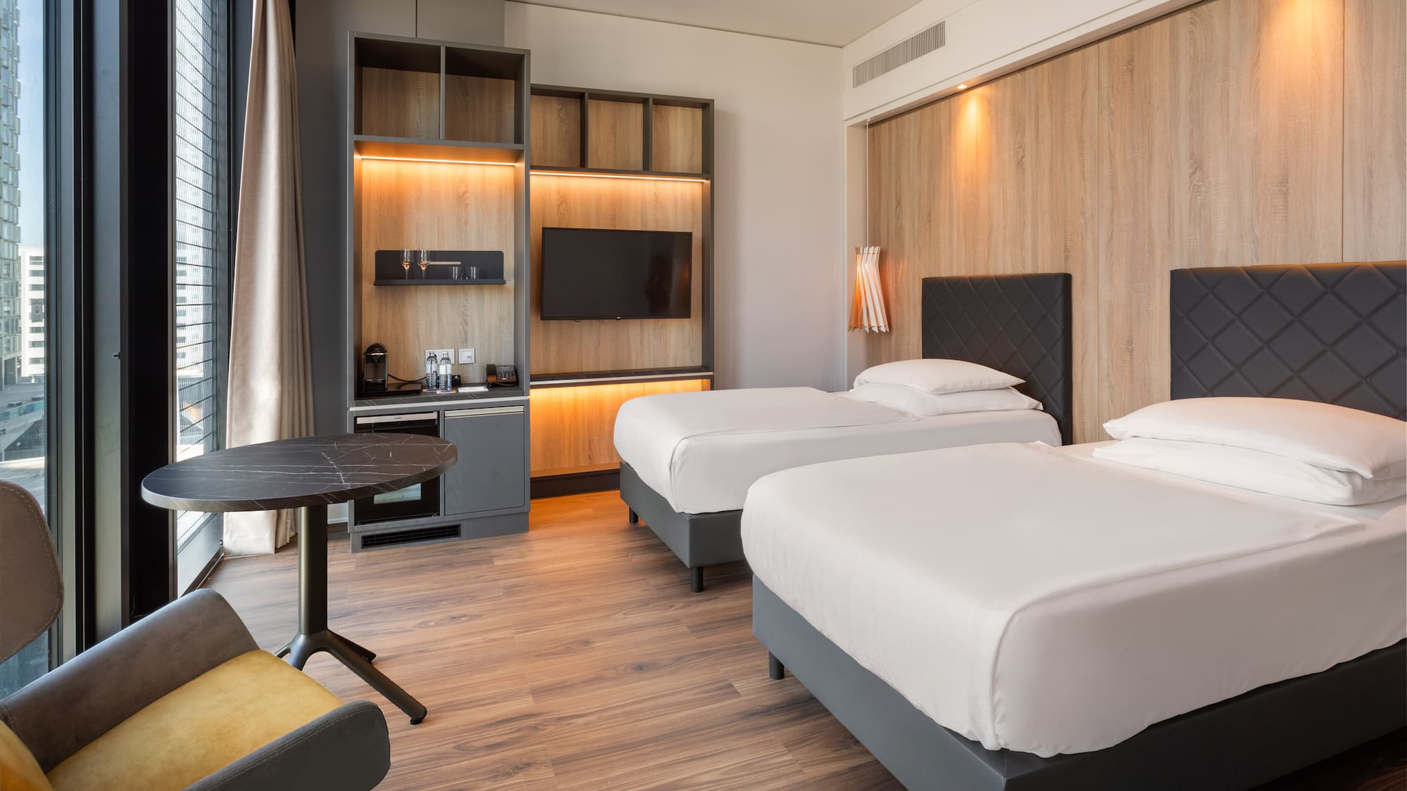 a room with two beds and a table