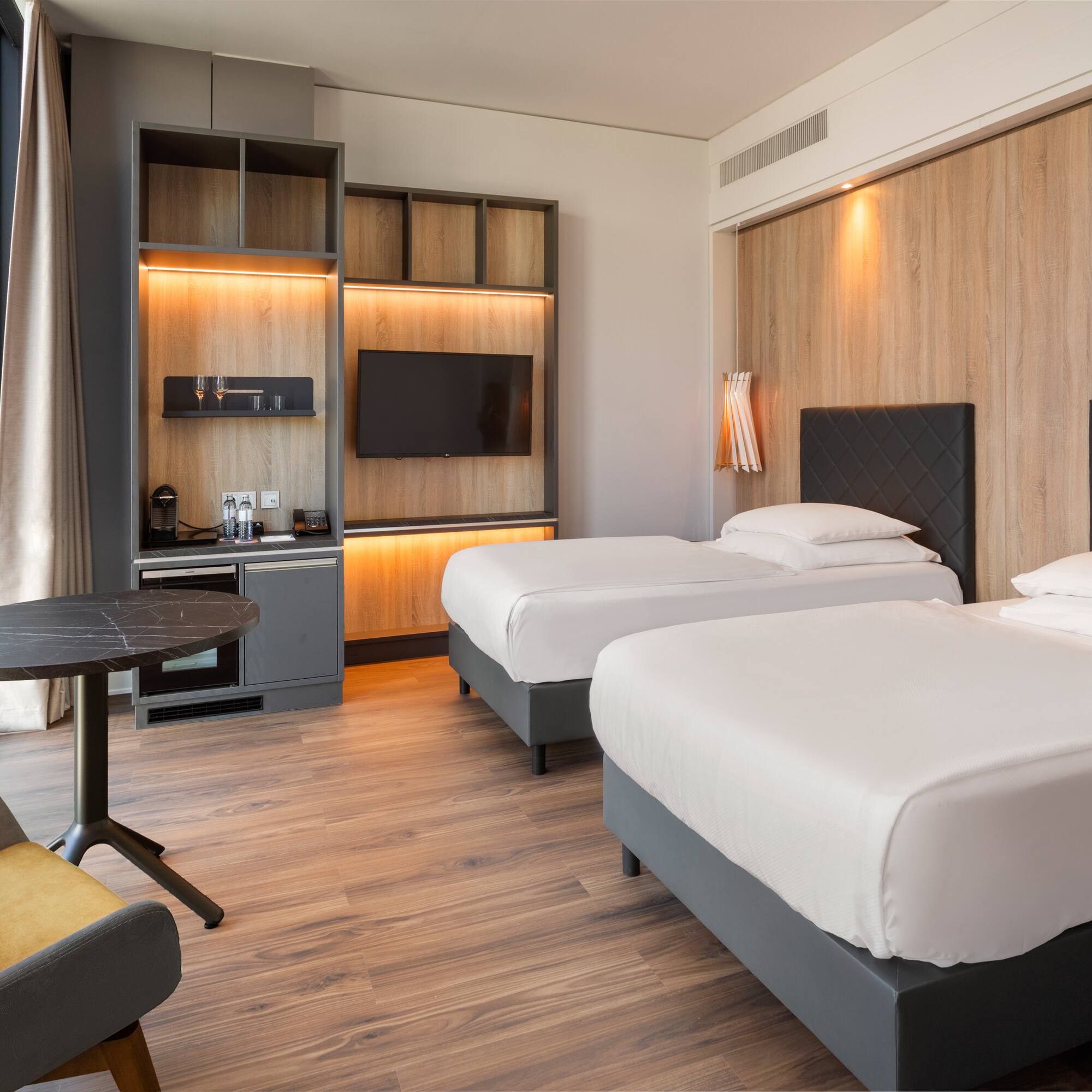 a room with two beds and a table