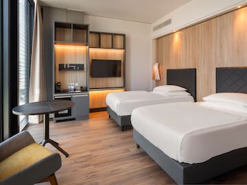 a room with two beds and a table