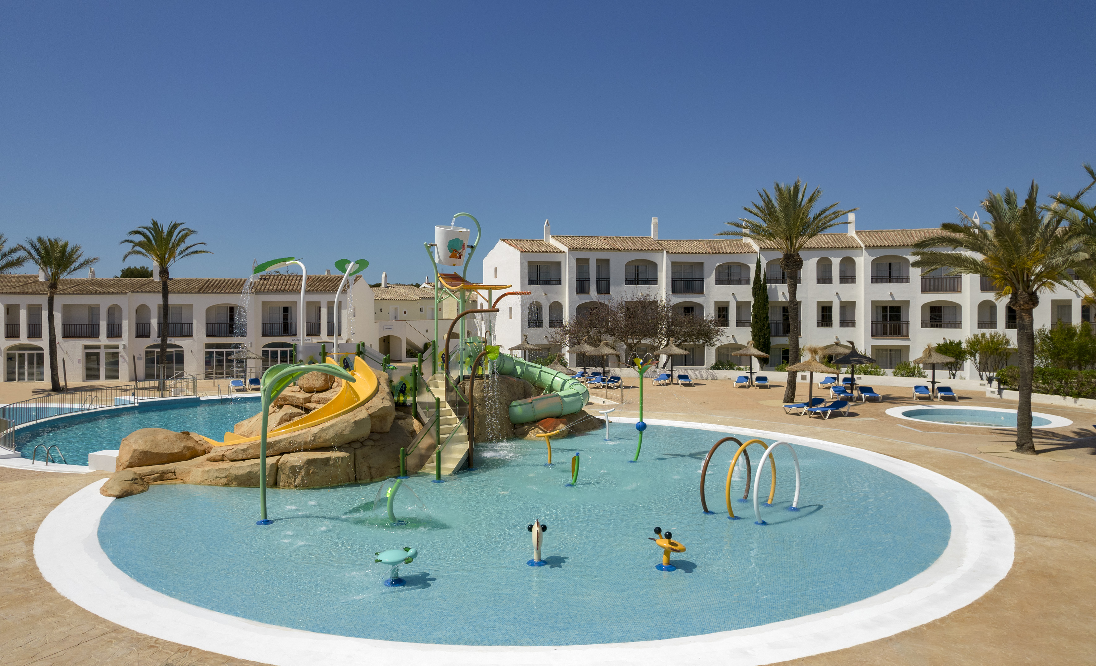 Sunny resort water park, kids splash pad, water slides, and hotel pools.