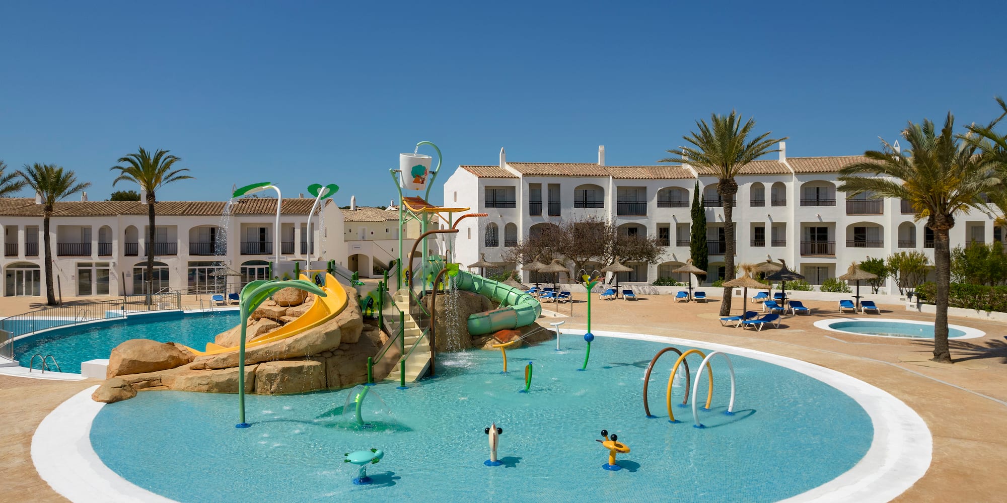 Sunny resort water park, kids splash pad, water slides, and hotel pools.