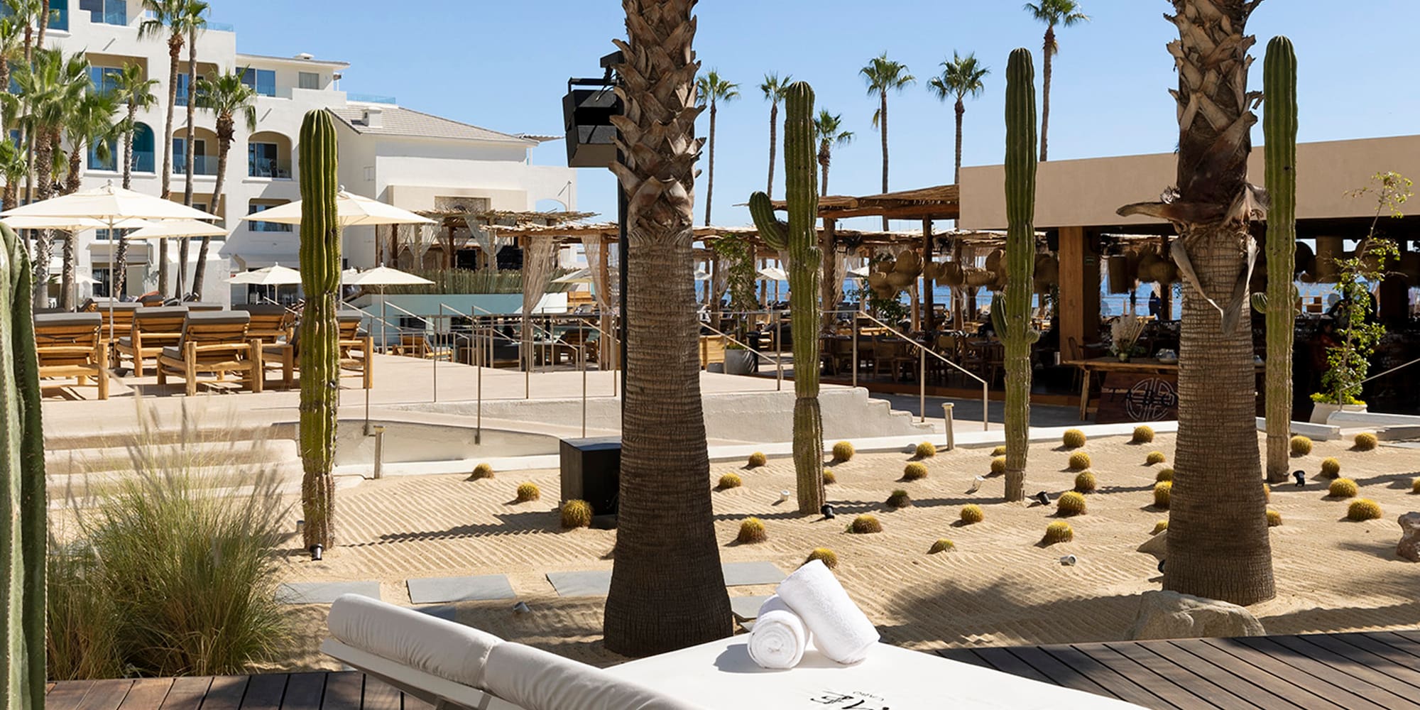 a lounge chair with towels rolled up on it