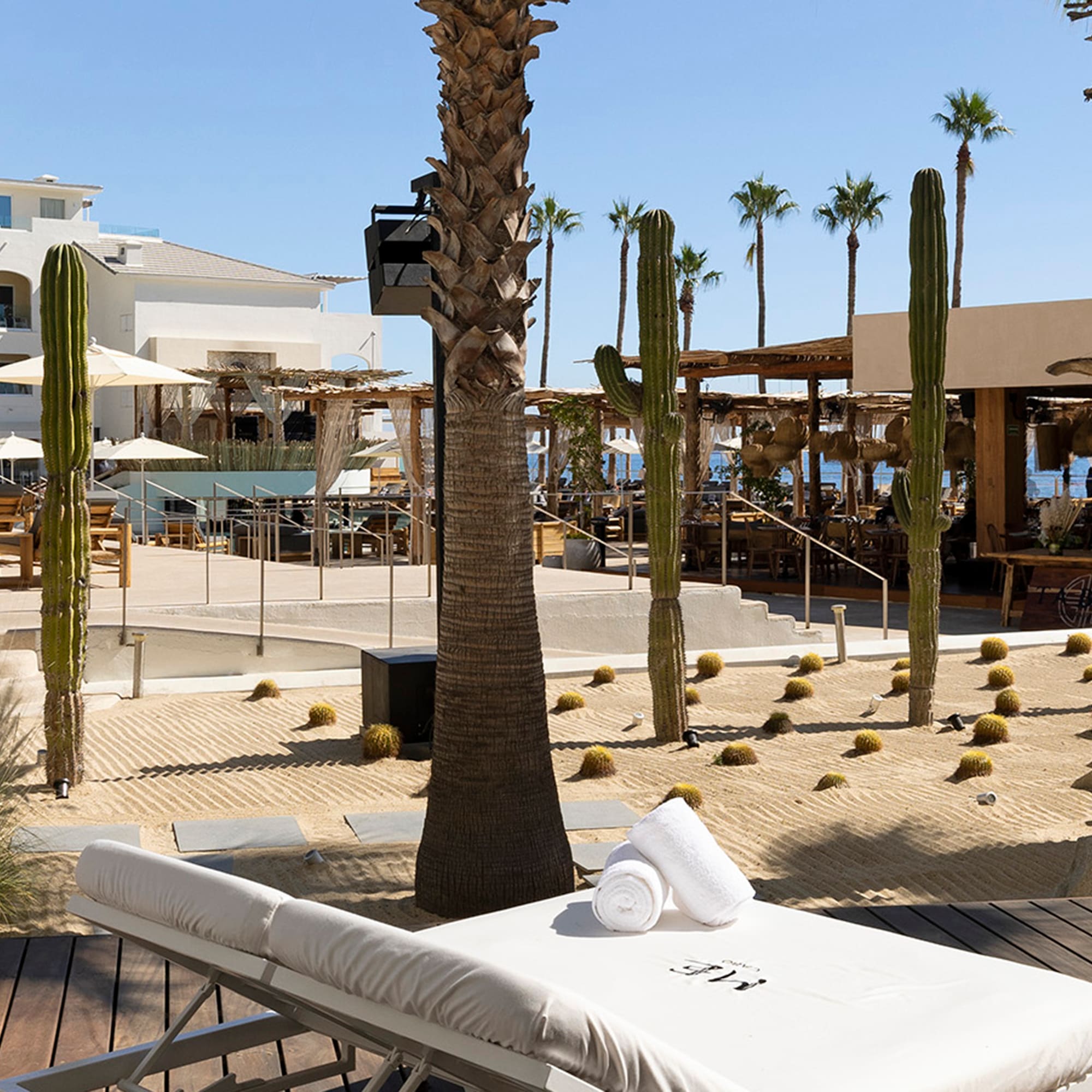 a lounge chair with towels rolled up on it