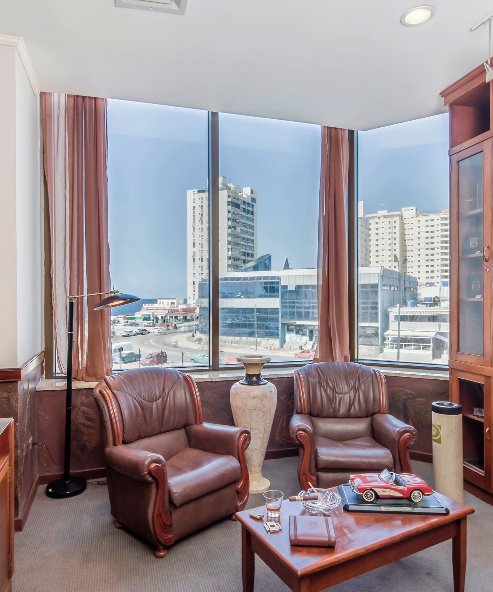 a room with a large window and chairs