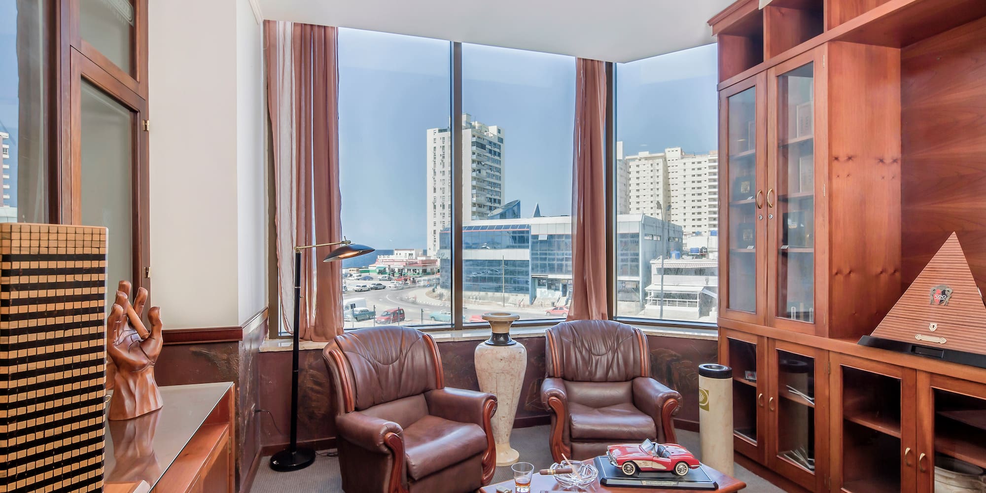 a room with a large window and chairs