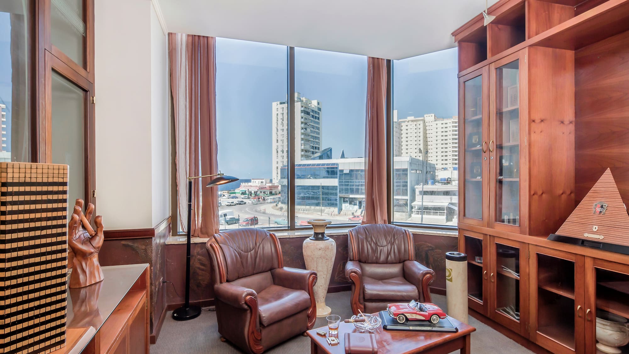 a room with a large window and chairs