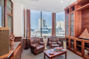 a room with a large window and chairs