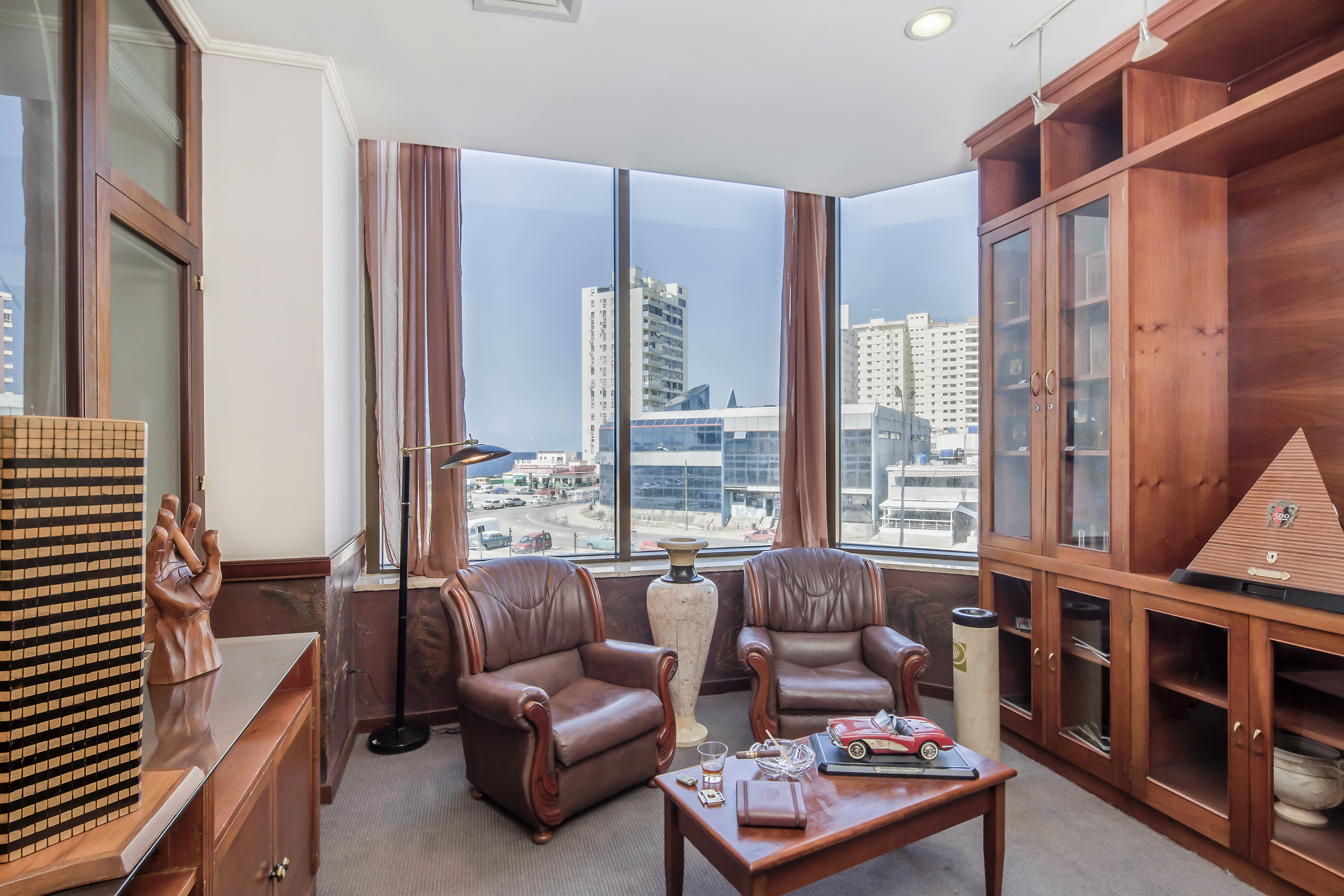 a room with a large window and chairs