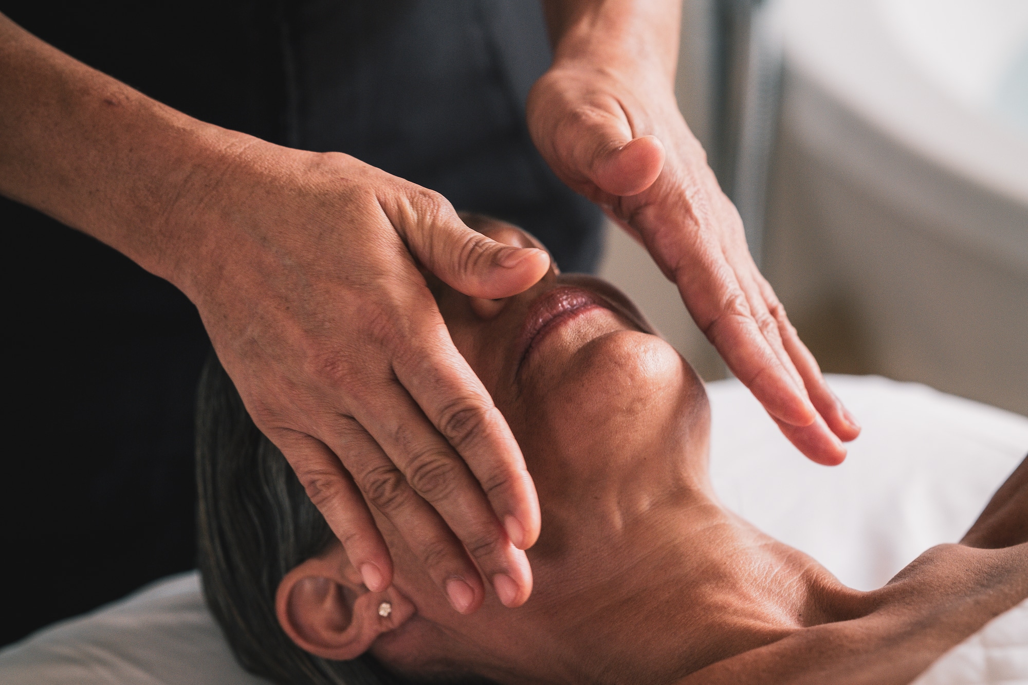 a person doing a face massage