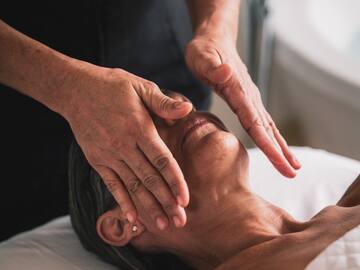 a person doing a face massage