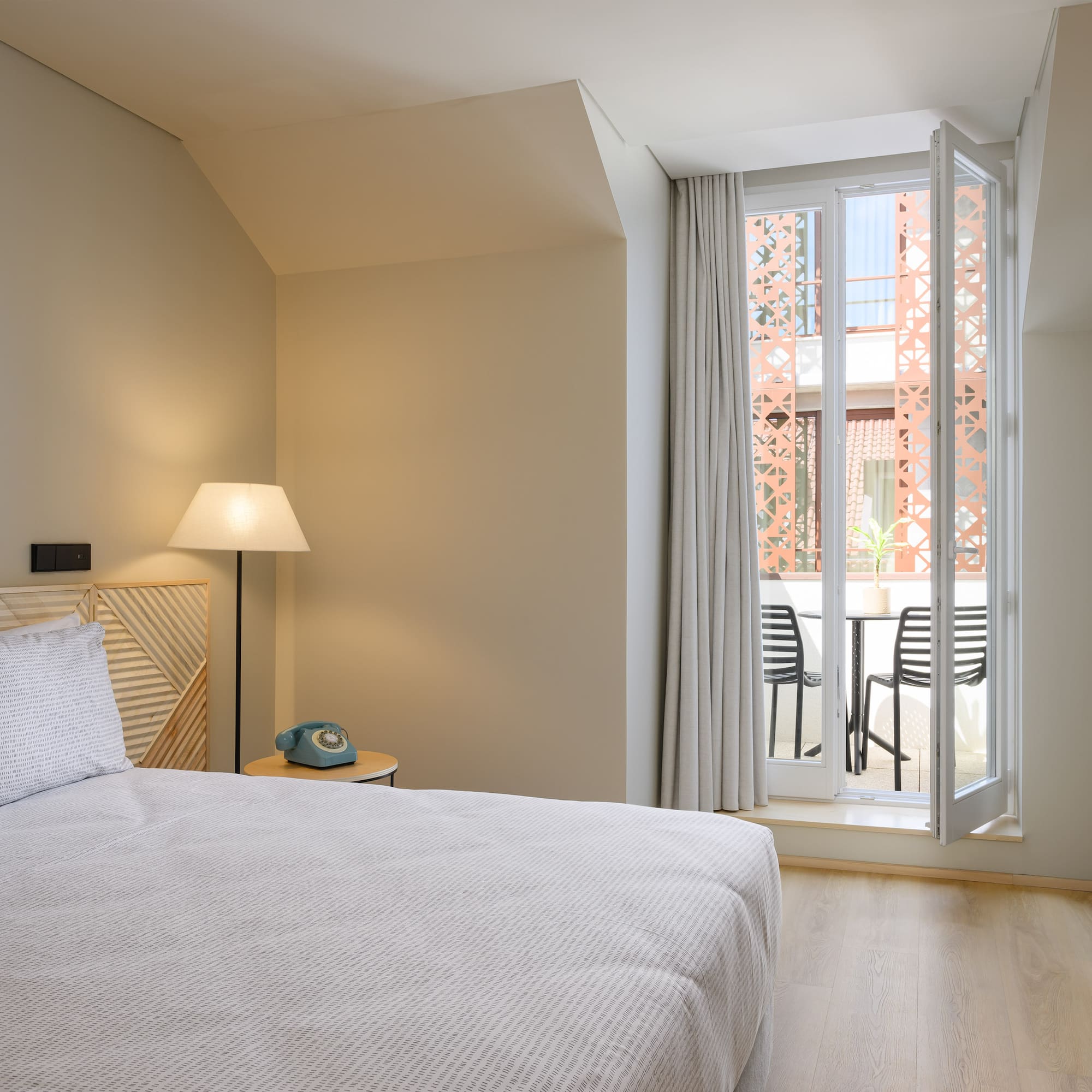 a bedroom with a bed and a door to a balcony