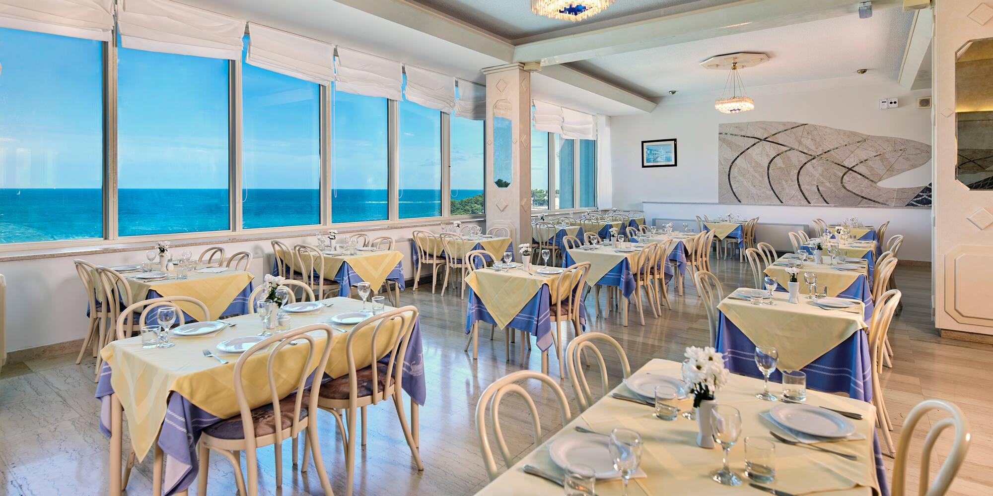 a room with tables and chairs and a chandelier