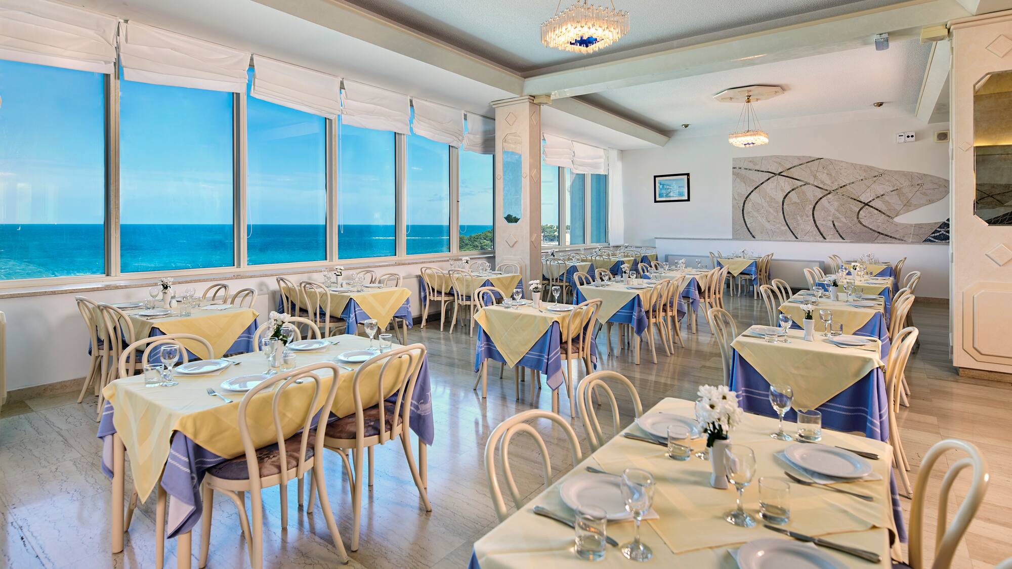 a room with tables and chairs and a chandelier