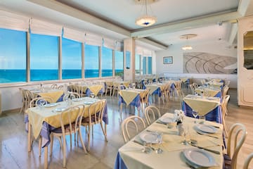 a room with tables and chairs and a chandelier