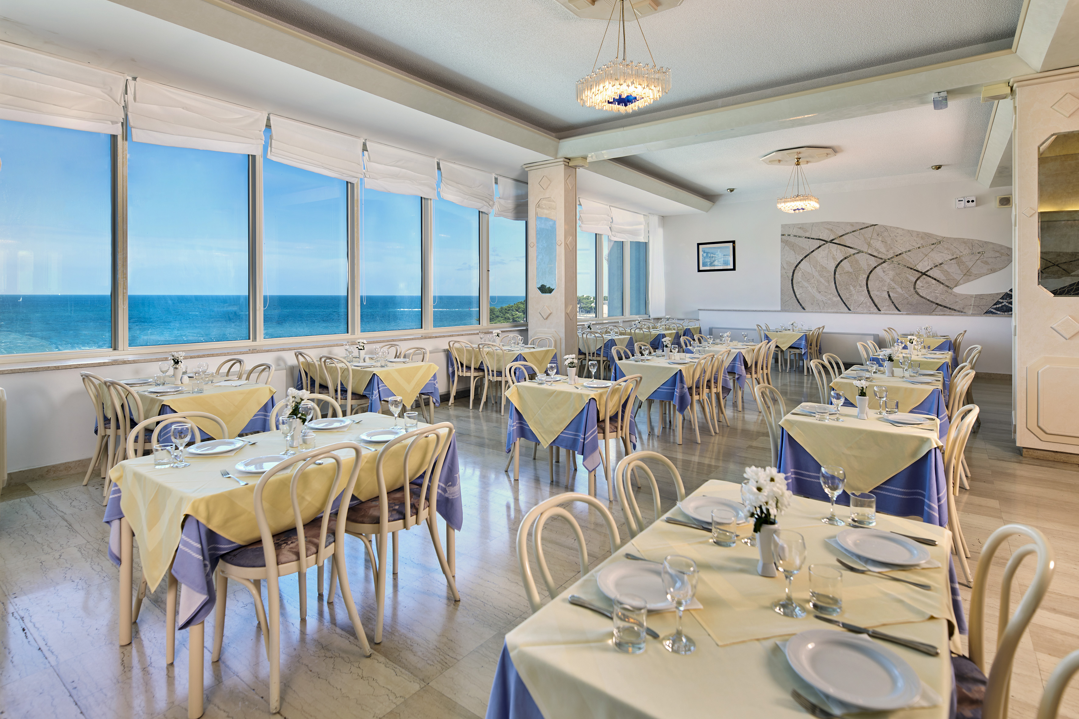 a room with tables and chairs and a chandelier