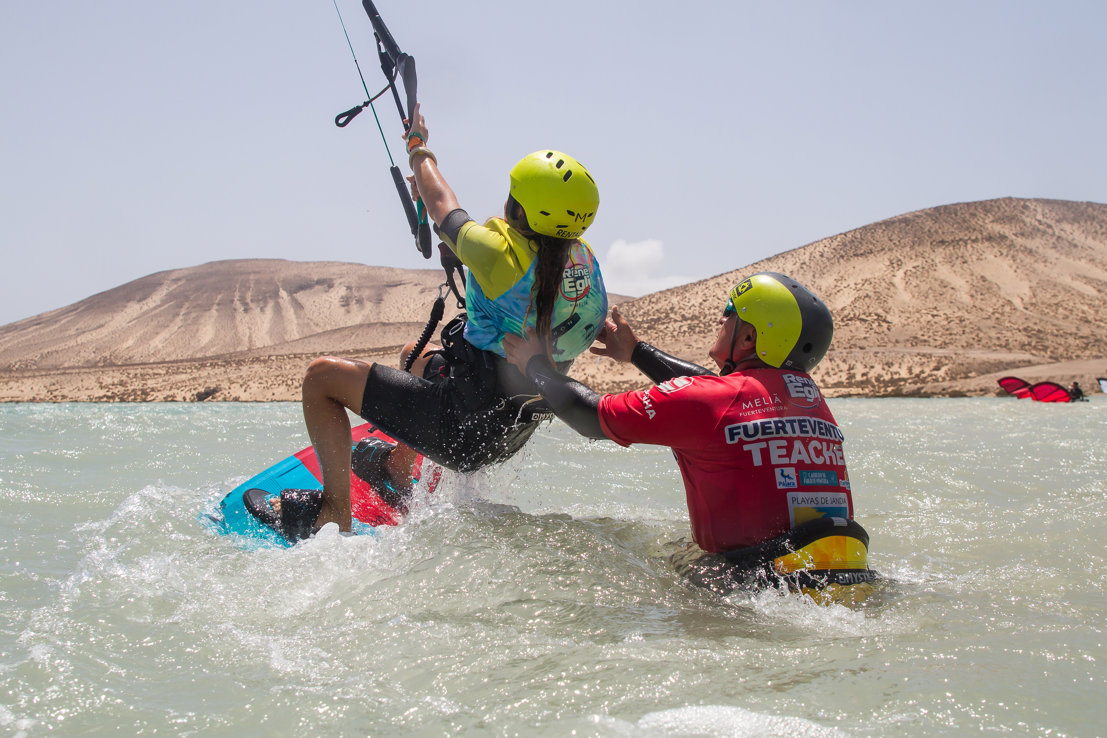 Kitesurfing instructor helping student learn in Fuerteventura waters.
