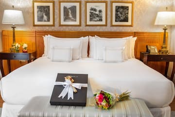 a bed with a gift and flowers