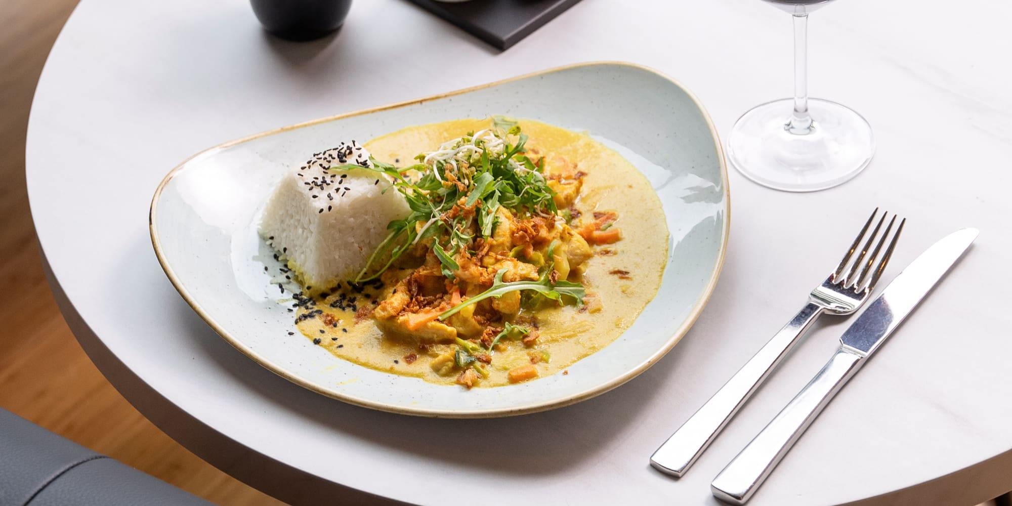 a plate of food and a glass of wine