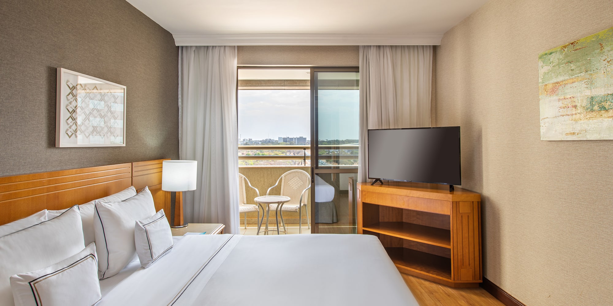 a room with a bed and a television