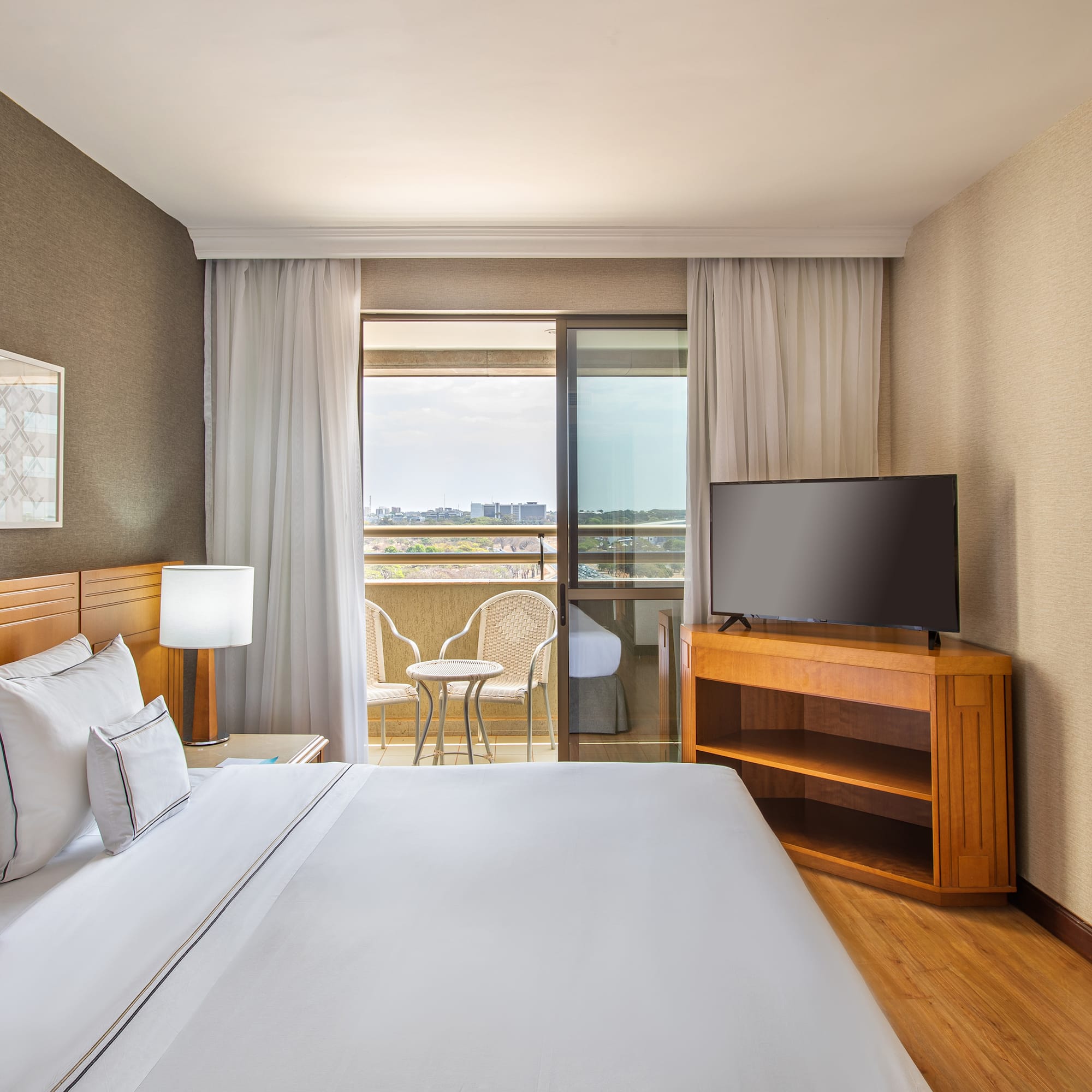 a room with a bed and a television