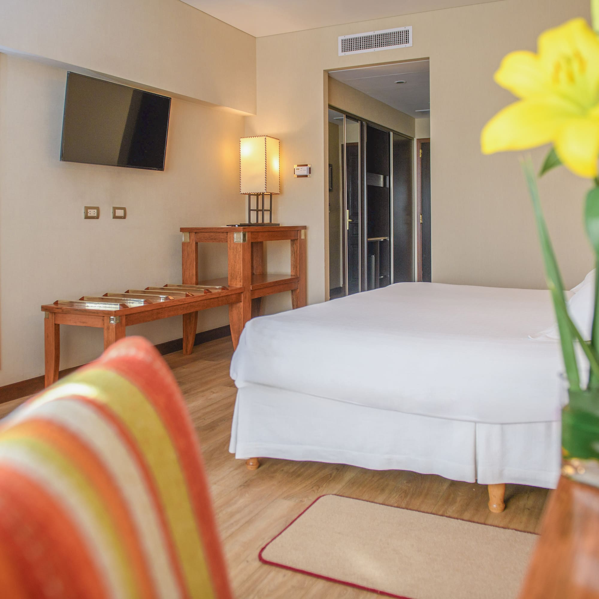 a room with a bed and a table and a television