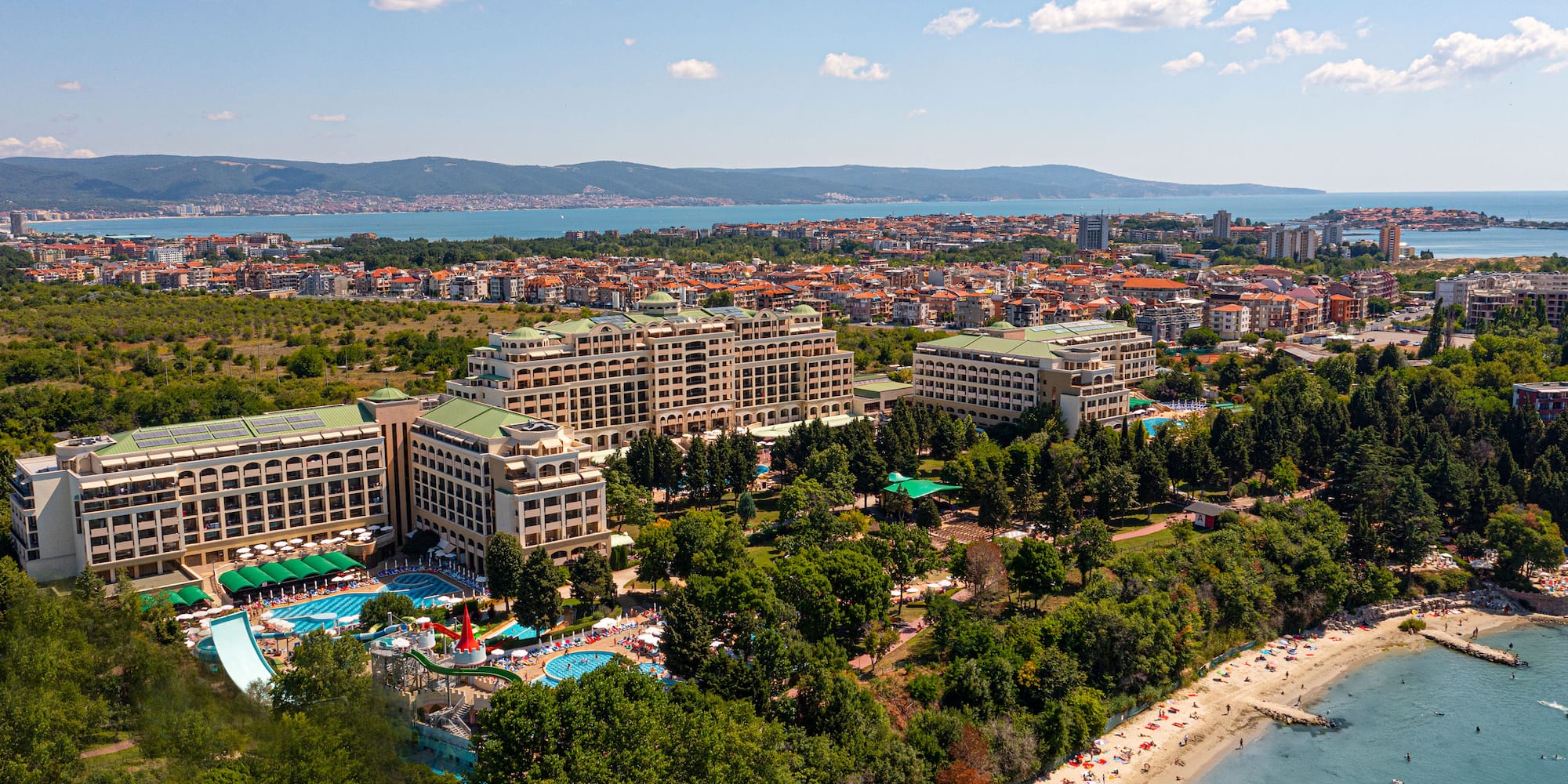 a large building next to a beach