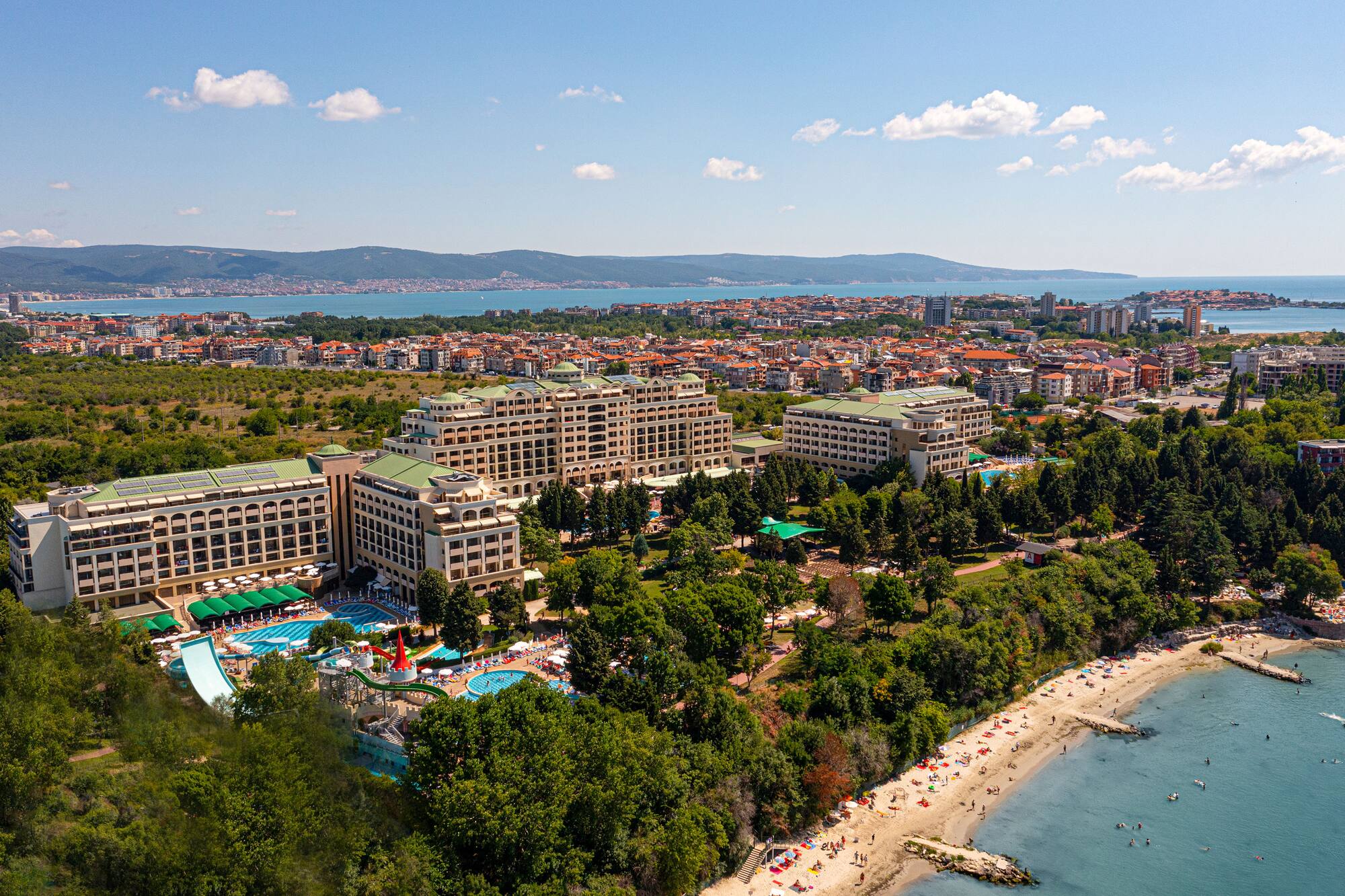 a large building next to a beach