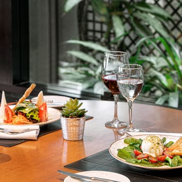 a table with plates of food and wine glasses