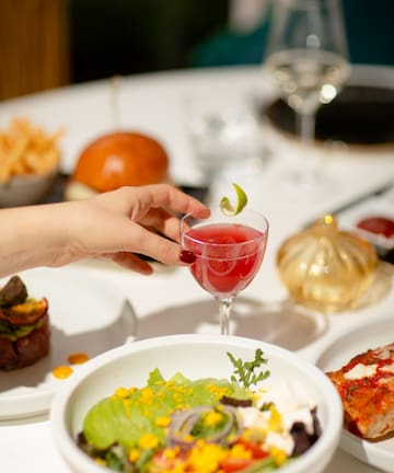 a hand holding a drink