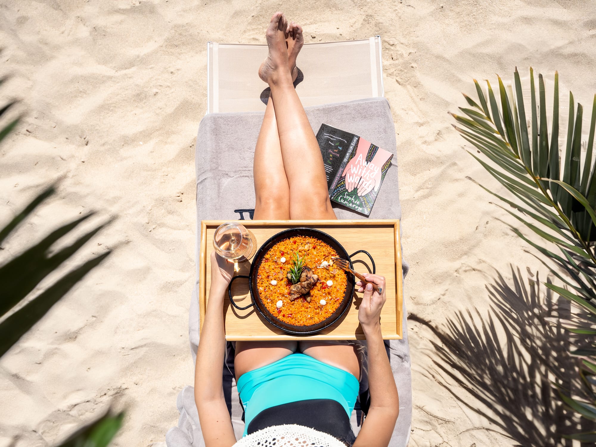 a woman eating food on a beach chair