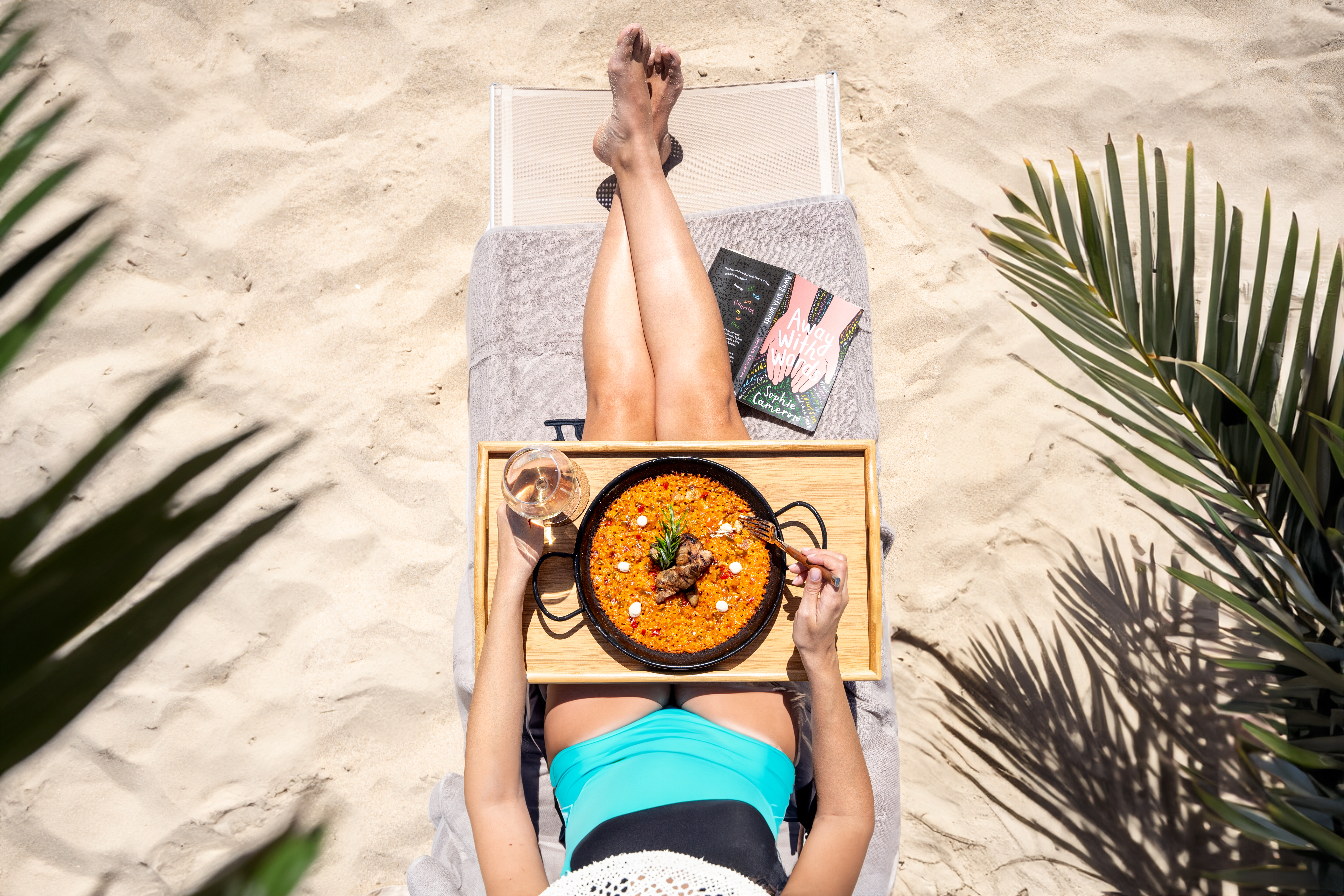 a woman eating food on a beach chair